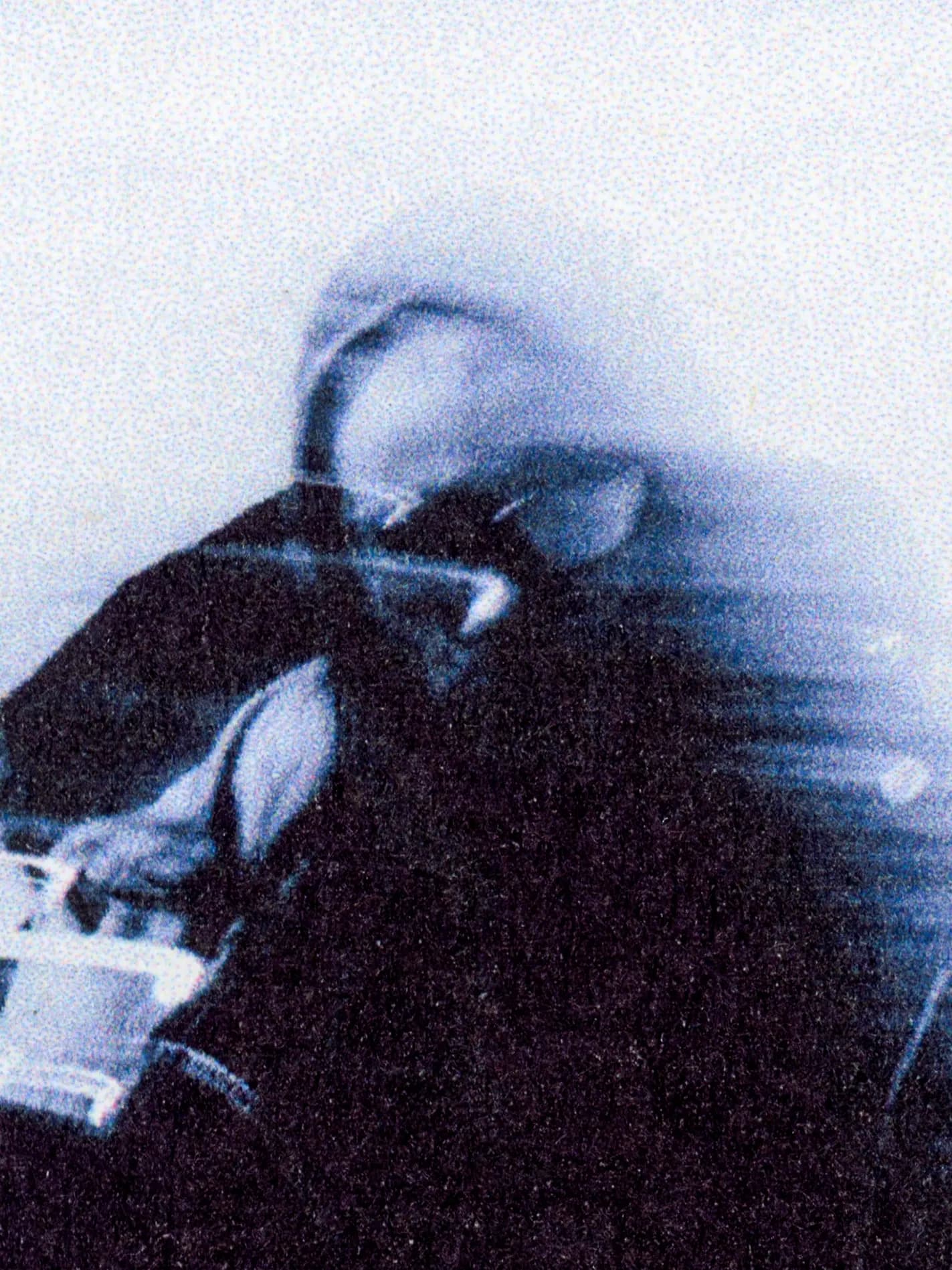 Portrait of person outdoors wearing Auclair jacket and glasses in natural light