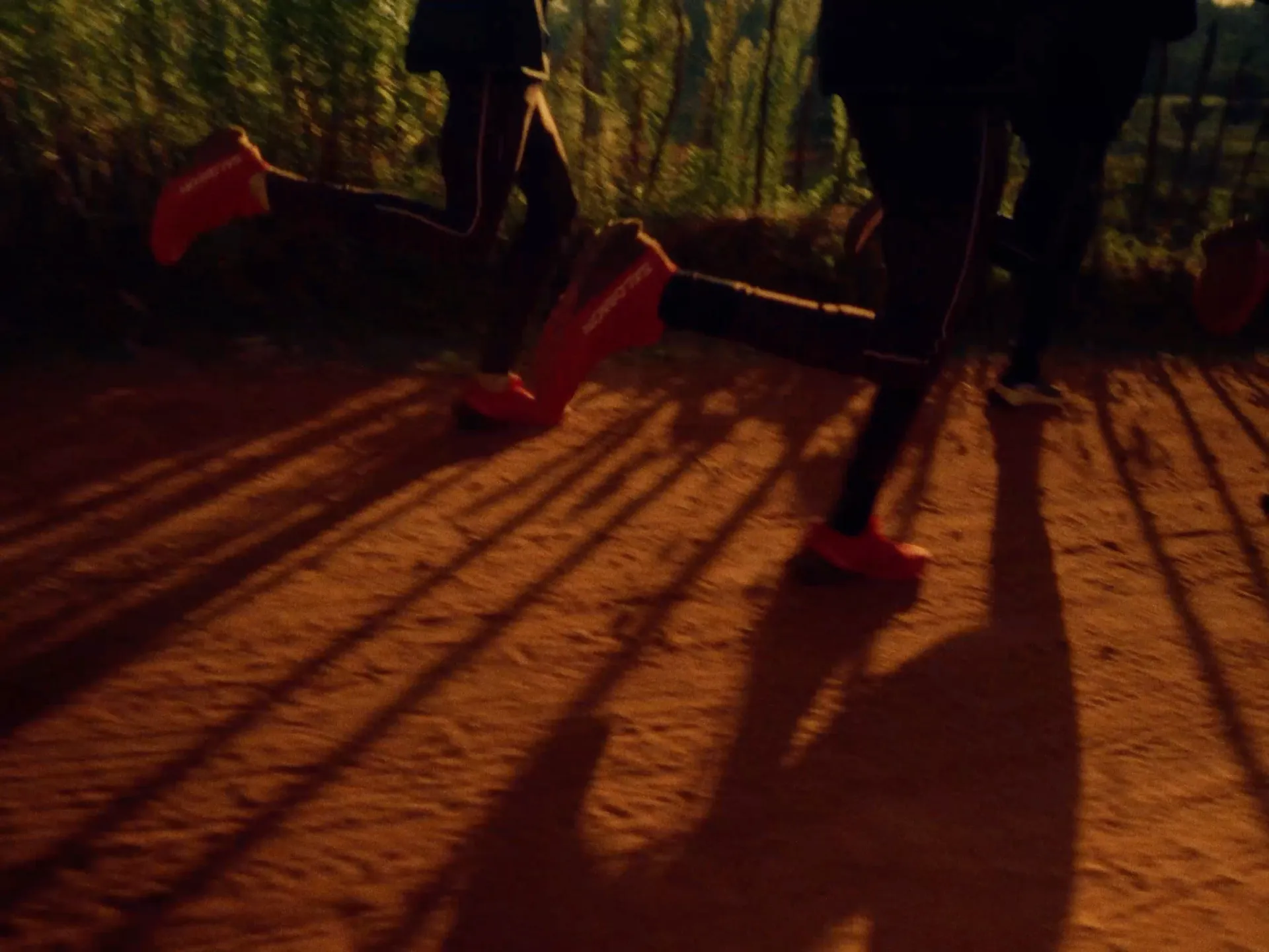 Person walking on trail wearing running shoes and clothing, Milimani project