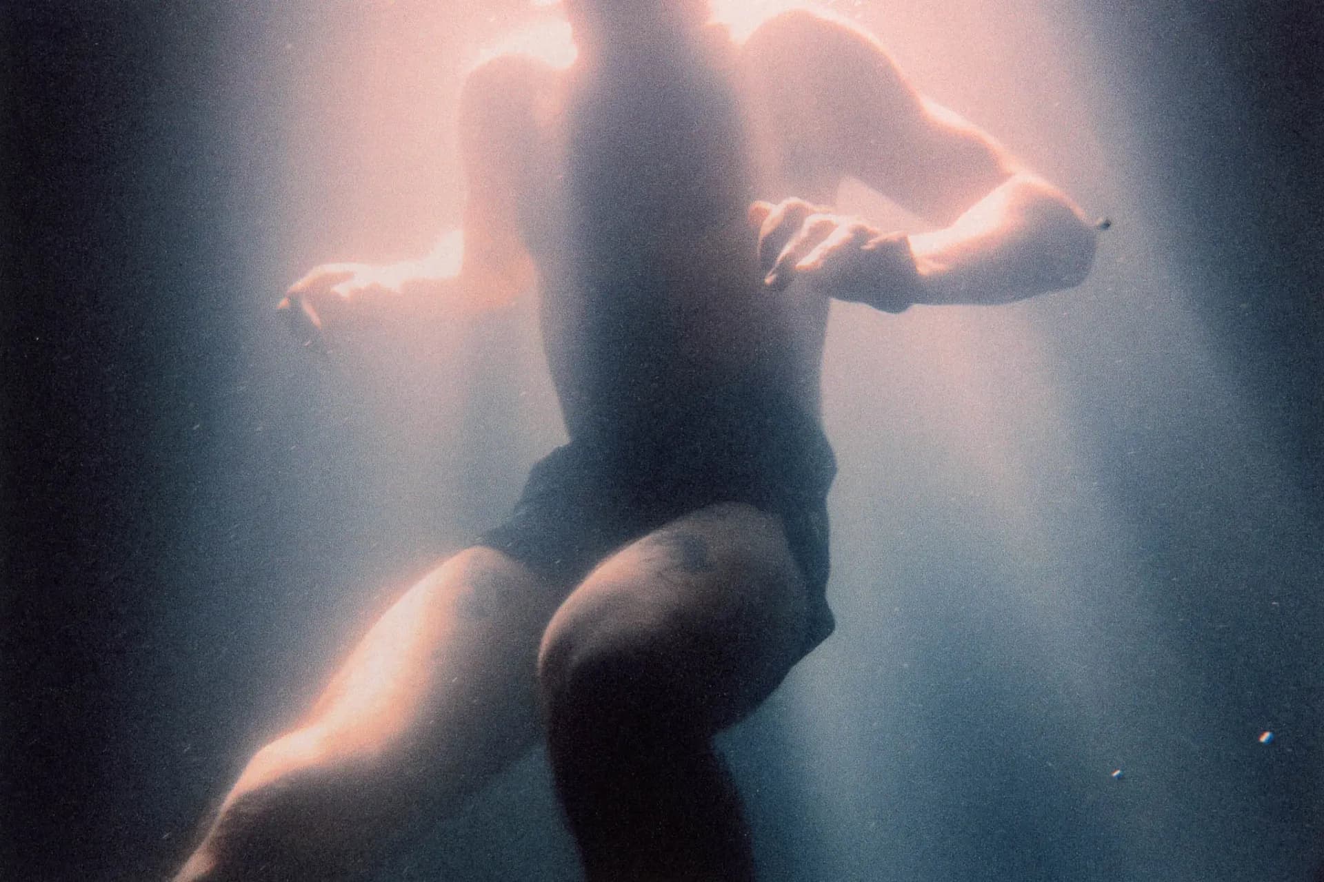 Ciele Summer Nights campaign — swimmer reaching through turquoise water in golden hour light