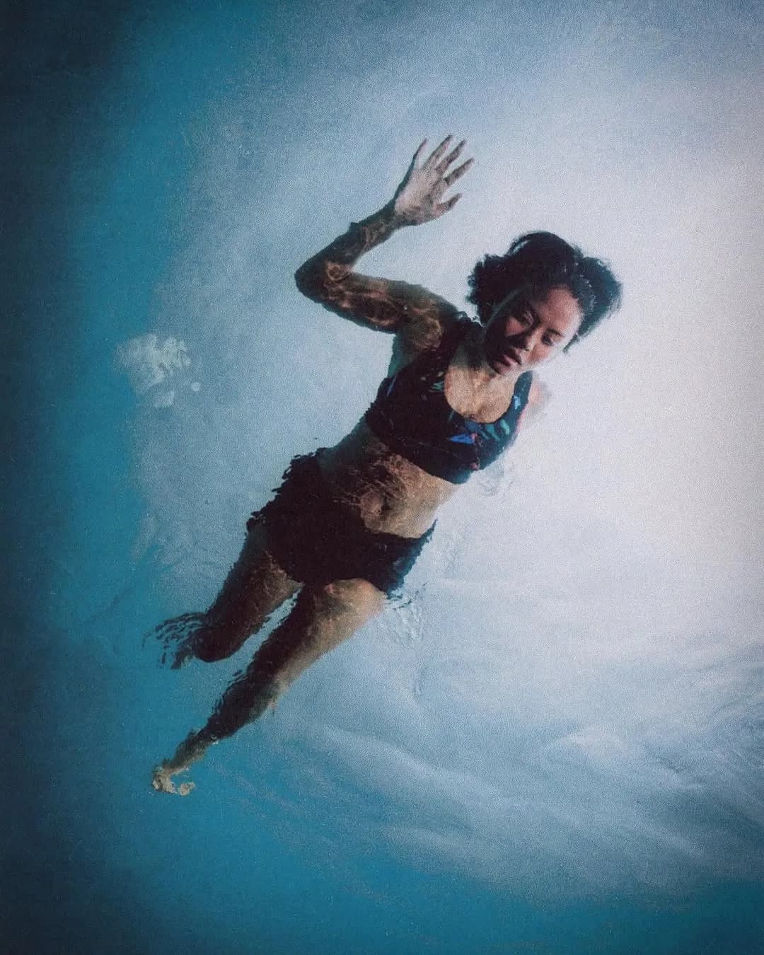 Person swimming in water wearing swimwear, Summer Nights outdoor portrait