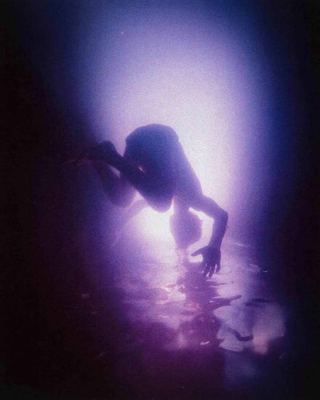 Performer dancing under purple lighting, Summer Nights nightlife editorial