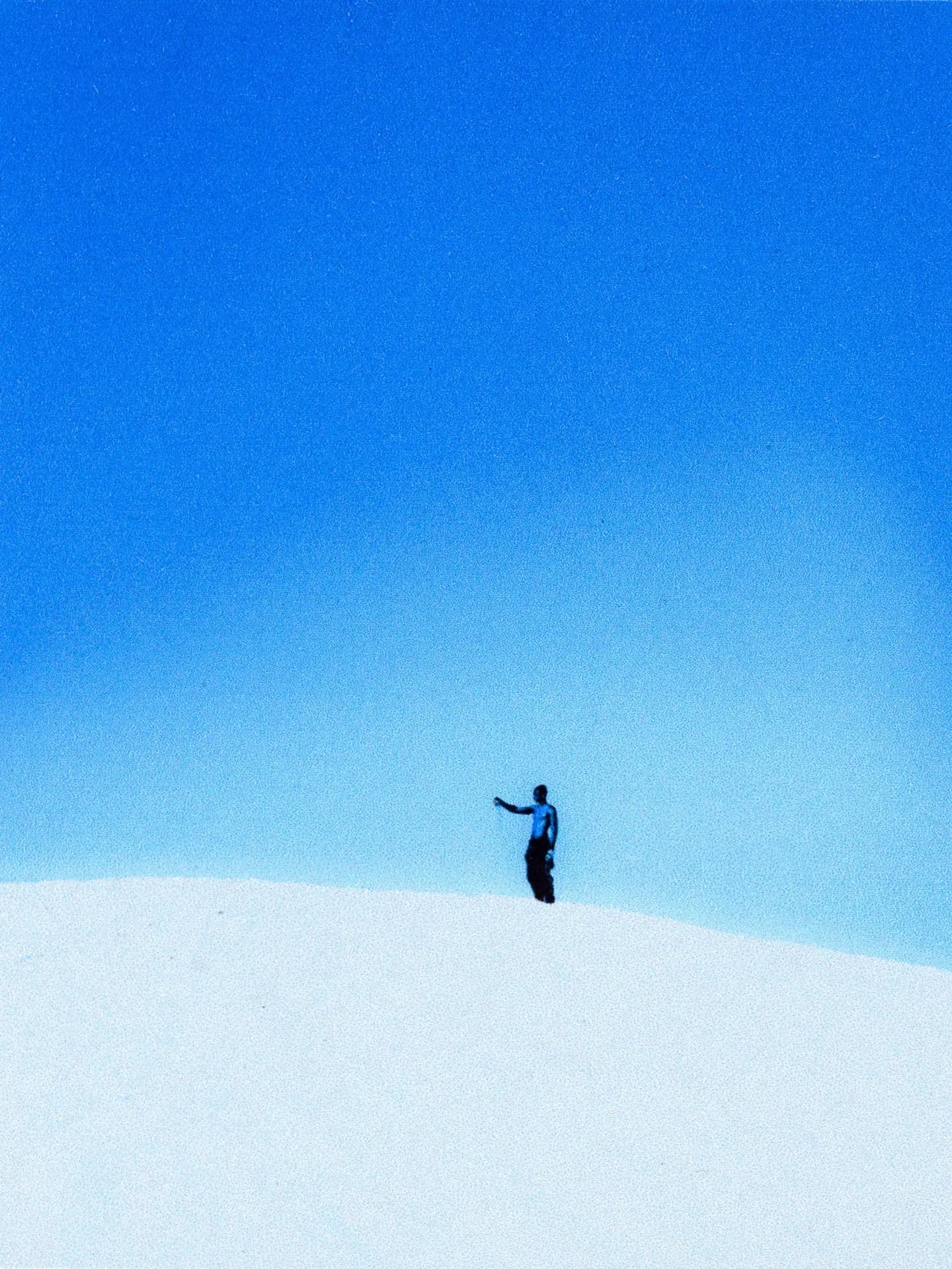 Hiker outdoors on a mountain slope with dramatic sky, Auclair outdoor apparel