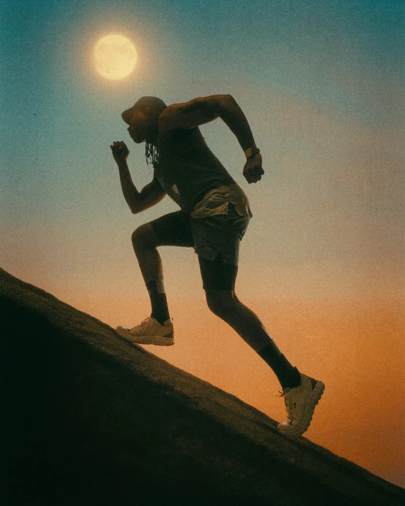 Man running in Ciele Le athletic footwear and sportswear